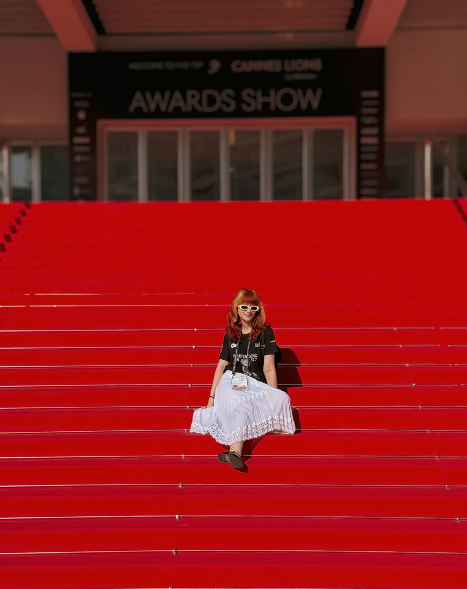 Julieta Calotă sitting on the red stairs of the Palais at Cannes Lions